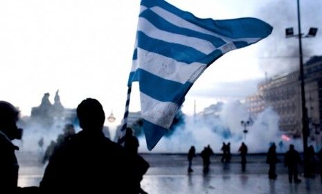 Protesters in front of Athens&amp;#039; Greek Parliament during clashes with riot police