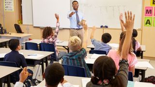 when do we go Back to School 2020 students classroom teacher raising hands