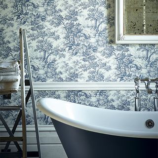 bathroom with floral printed walls and bathtub