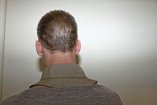 back of male model with slicked back hair