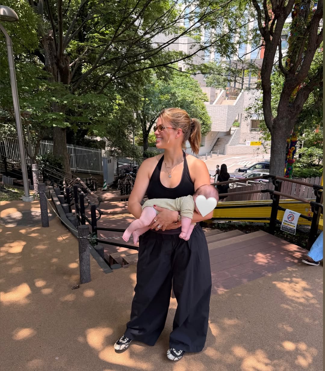 Sofia Richie Grainge shares photos wearing an Adidas track jacket, black baggy pants, and Prada snakeskin ballet sneakers, along with white shorts during a trip to Japan