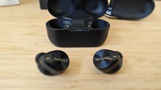 Panasonic Technics EAH-AZ80 earbuds sitting on a desk
