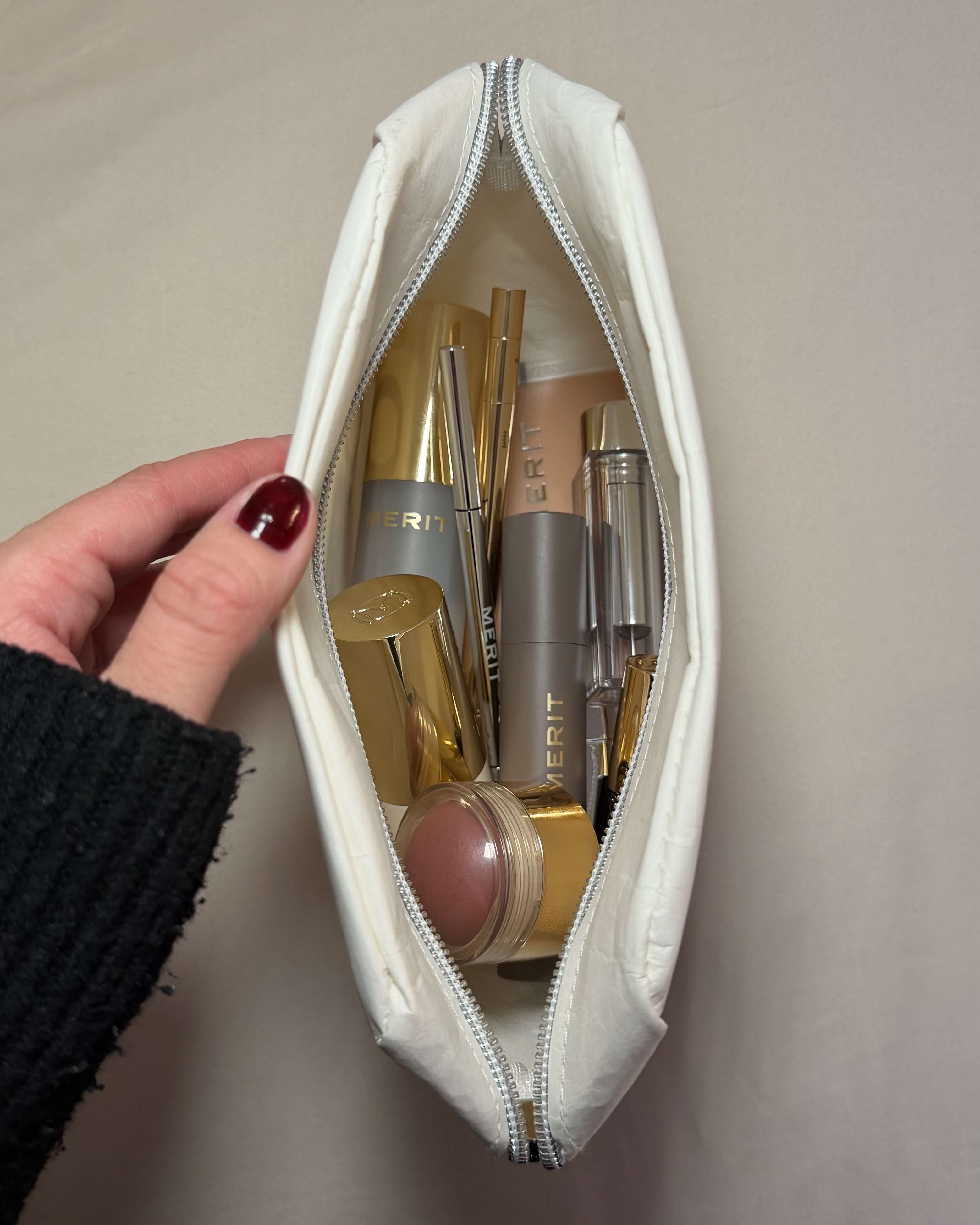 Brascia with a bag full of Merit beauty products.