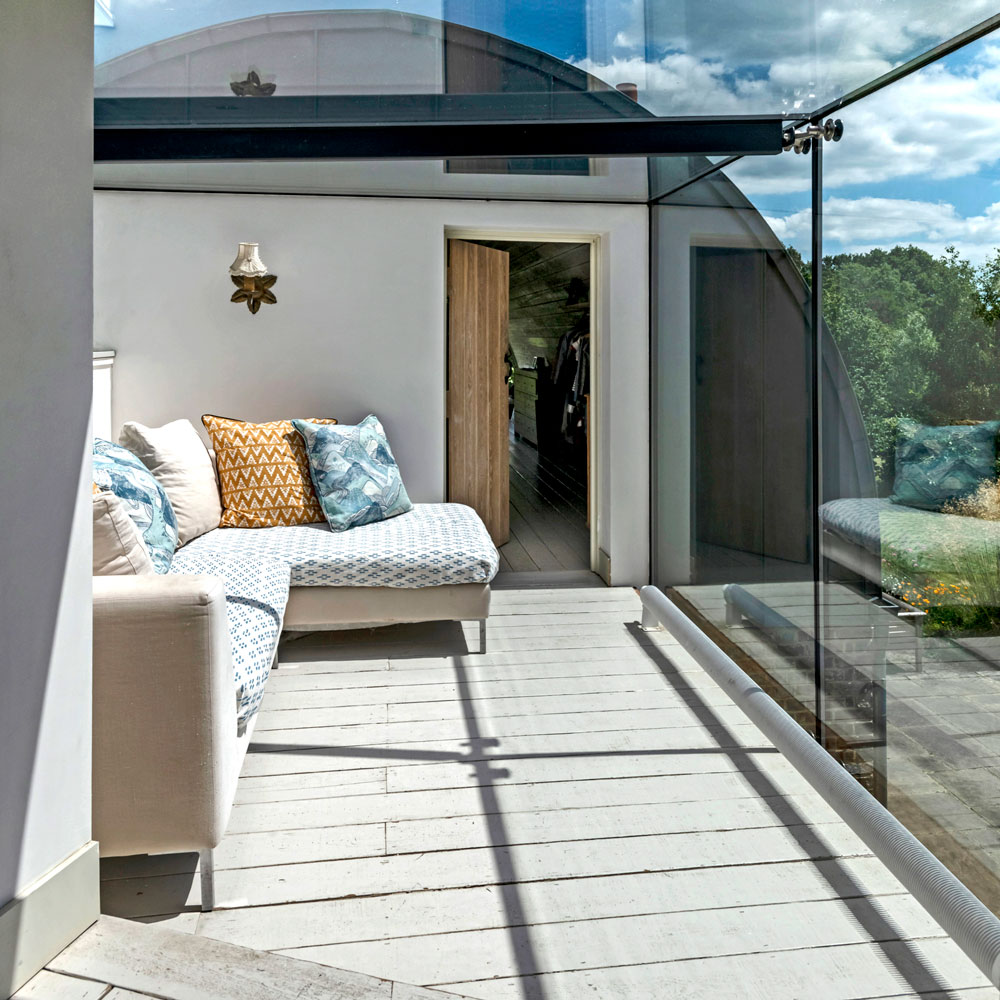 Glass extension with sofa inside