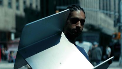 man with aluminium side table
