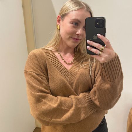 Woman wears camel v-neck jumper