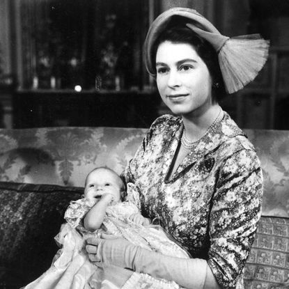 Queen Elizabeth holding Princess Anne on her christening day
