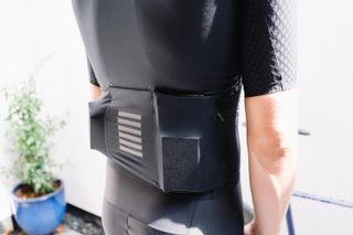 A closeup of the rear pockets on a black cycling jersey