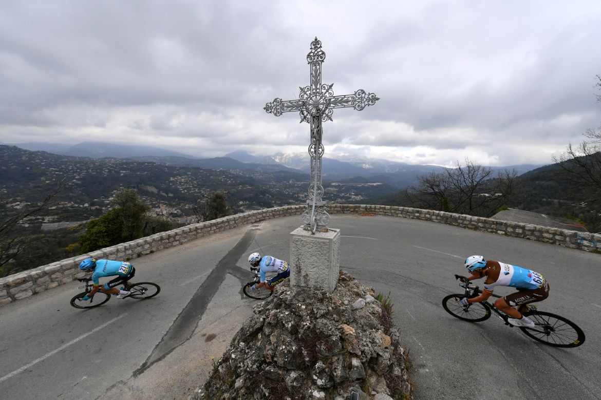 The riders round a corner on a descent