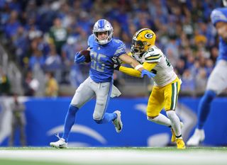Tom Kennedy #85 of the Detroit Lions stiff arms Jaire Alexander #23 of the Green Bay Packers in the second quarter at Ford Field on November 06, 2022 in Detroit, Michigan