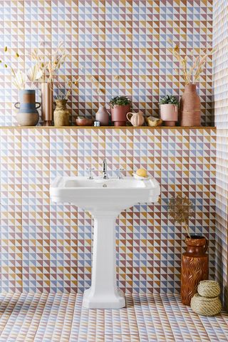A bathroom with multicolored graphic wall tiles