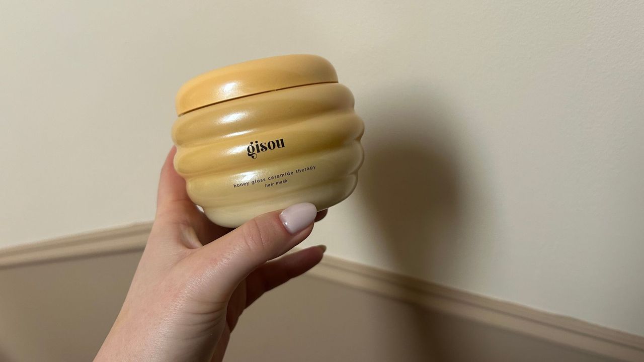 Tori holding the Gisou Honey Gloss Ceramide Therapy Hair Mask