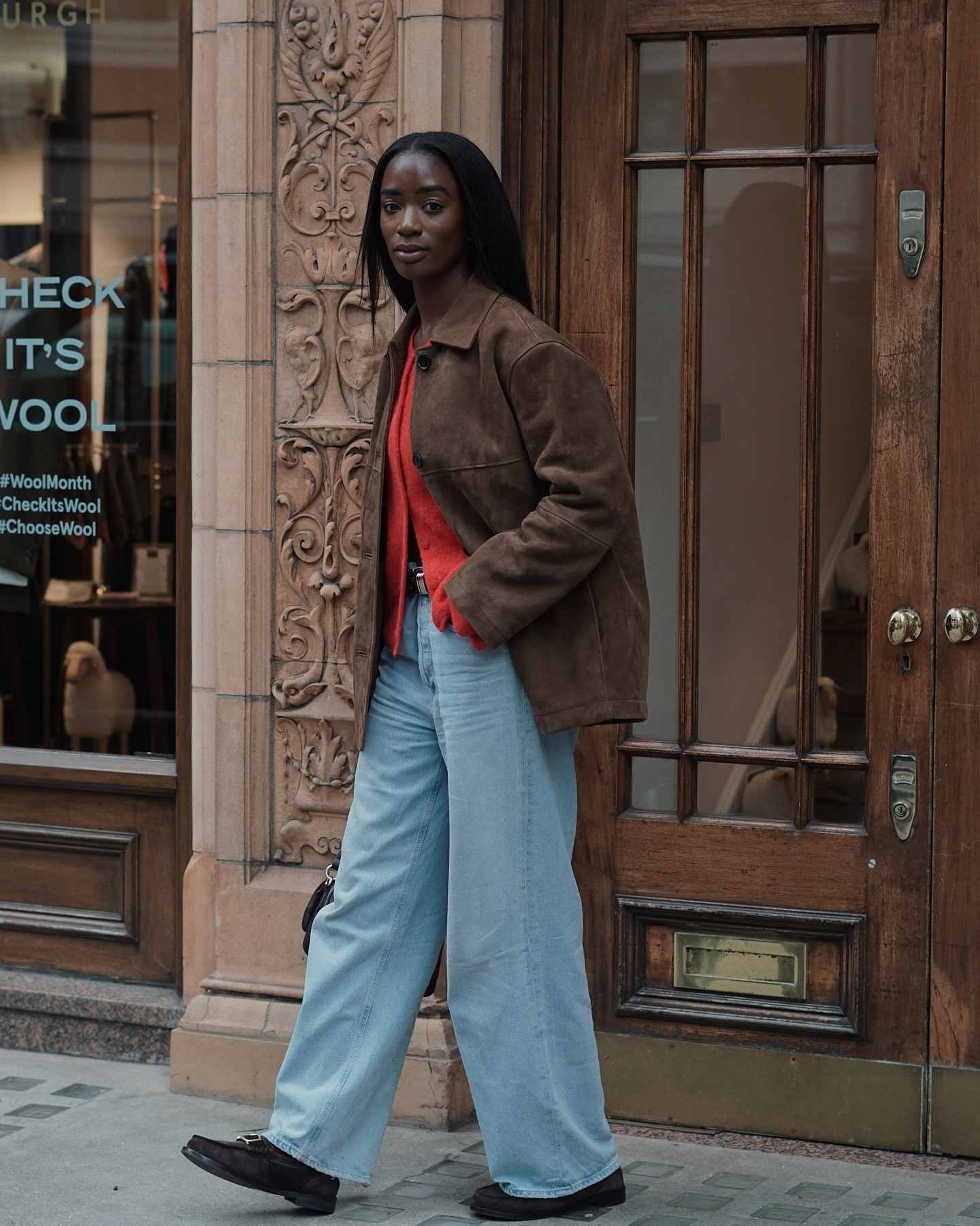 Woman wearing wide leg jeans with spring 2026 shoe trend.