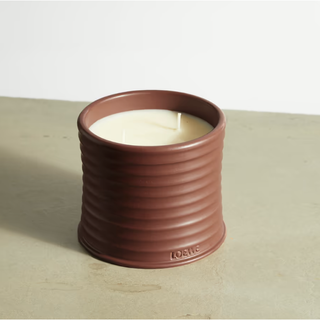 scented candle in a brown earthenware pot