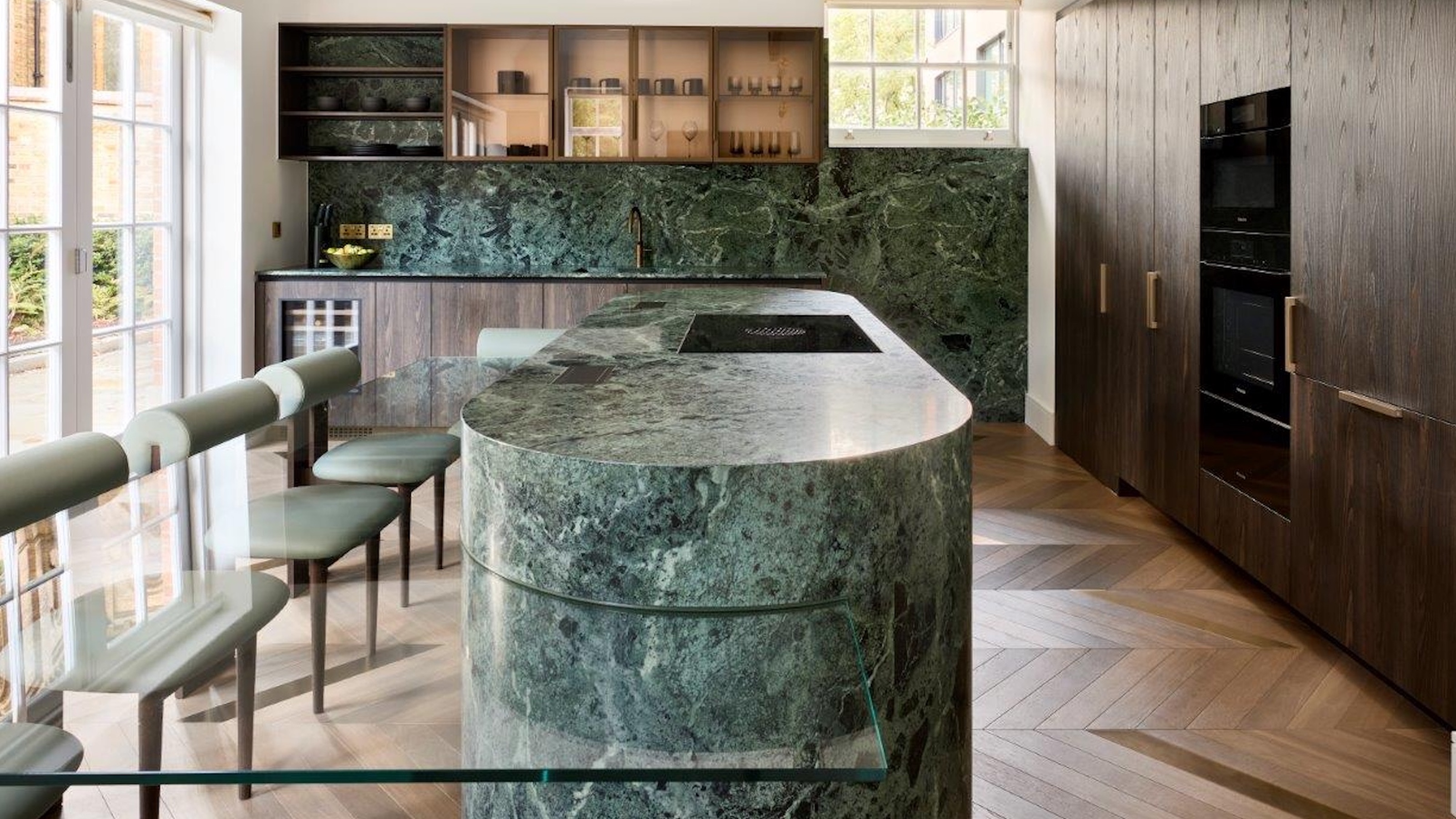kitchen with green pill shape island and glass table