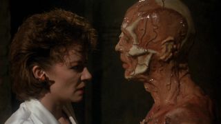 Julia standing with skinless Frank in Hellraiser