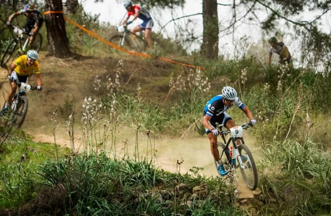 Emil Lindgren leading Fabian Giger, wearing the yellow race leader's jersey, on a descent at the Cyprus Sunshine Cup.