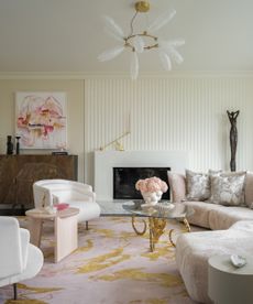 living room with curved sofa and pink rug