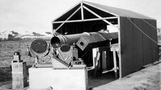 A photograph of the scientists' setup to measure the May 29, 1919 total solar eclipse from Sobral, Brazil. Two heliostats with moveable mirrors directed images of the sun into two horizontal telescopes.