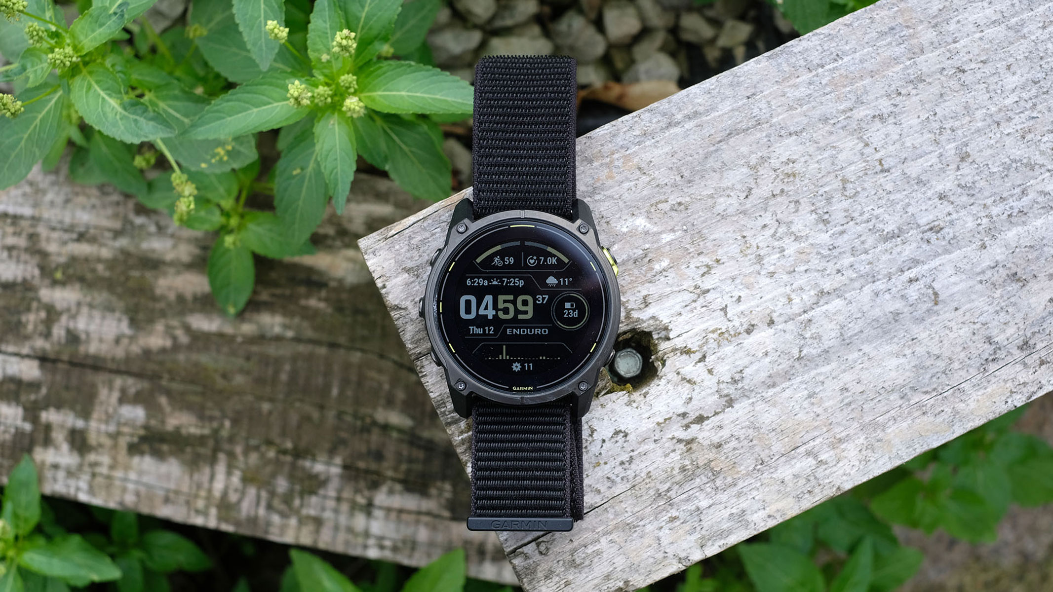 A picture of the Garmin Enduro 3 smartwatch sitting on top of a wooden plank