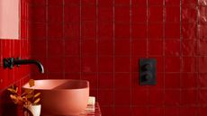 A bathroom with bright red tiles
