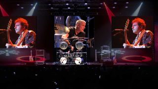 Carl Palmer onstage with video screens showing Greg Lake