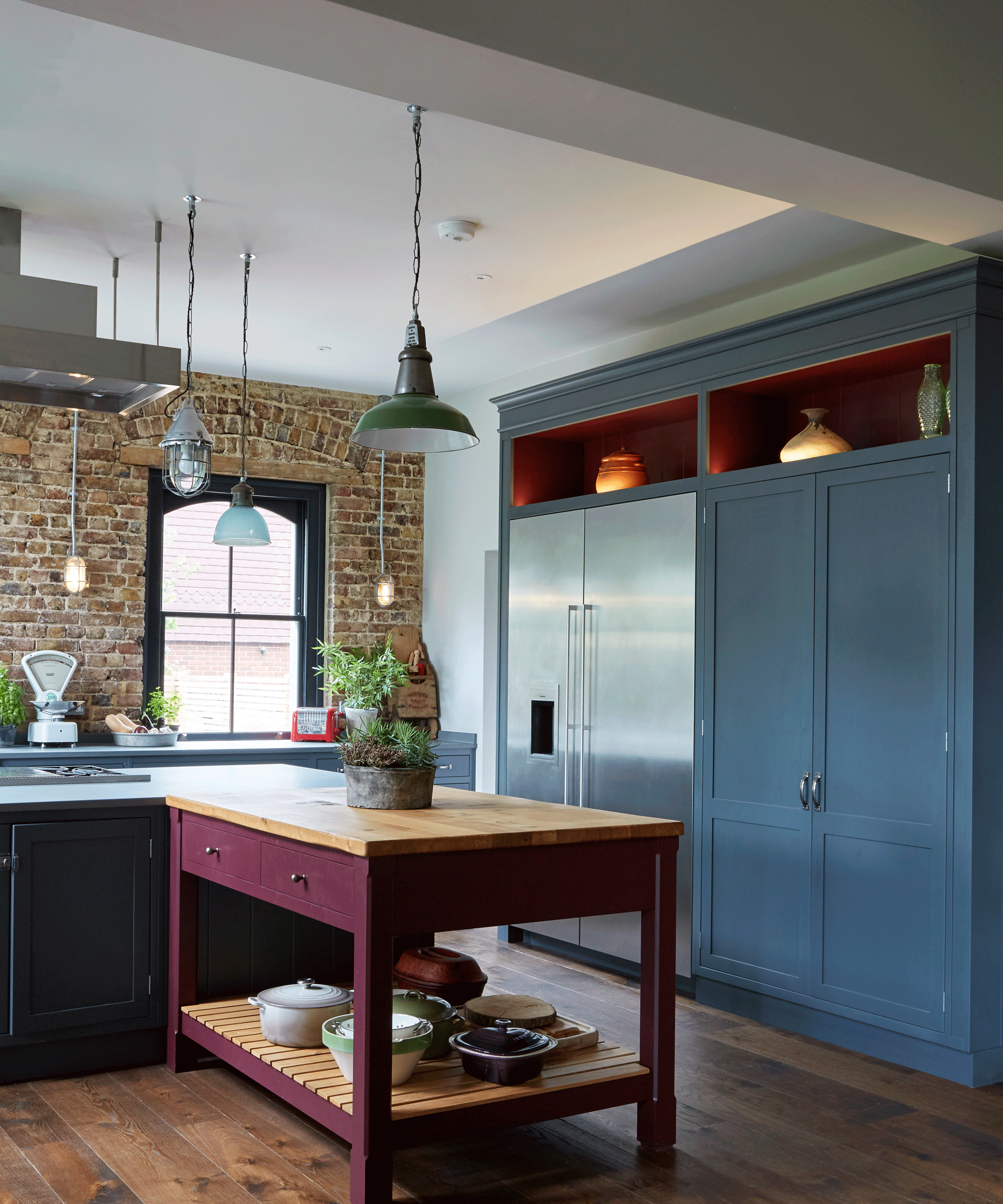 Blue kitchen with red alcoves and purple freestanding kitchen island