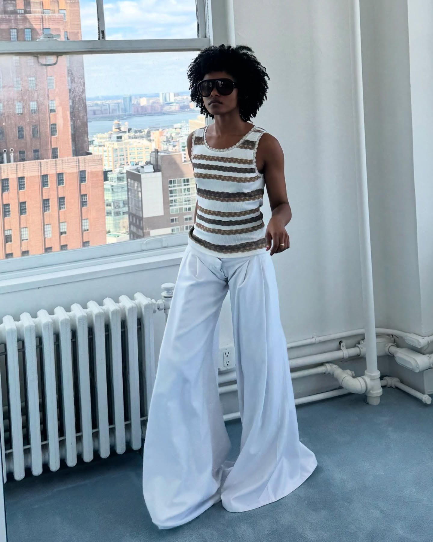 An image of @isthisfate wearing a fine knit tank top with wide-leg pants.