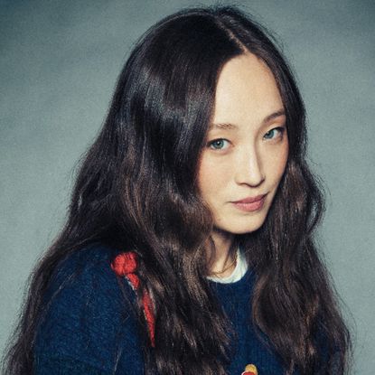 havana rose liu wears her hair in waves down long and a sweater in a headshot