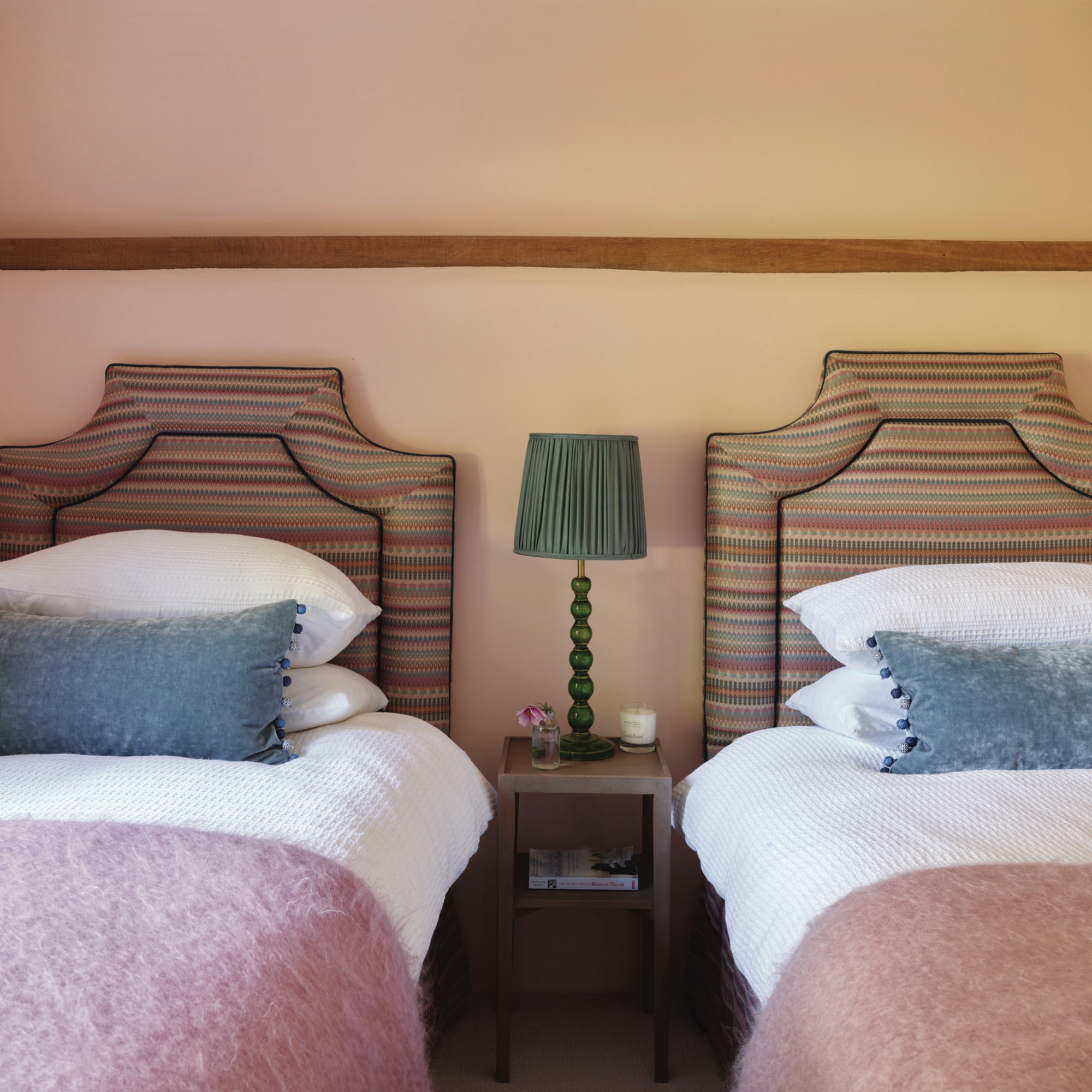 twin beds with striped headboards in pink bedroom