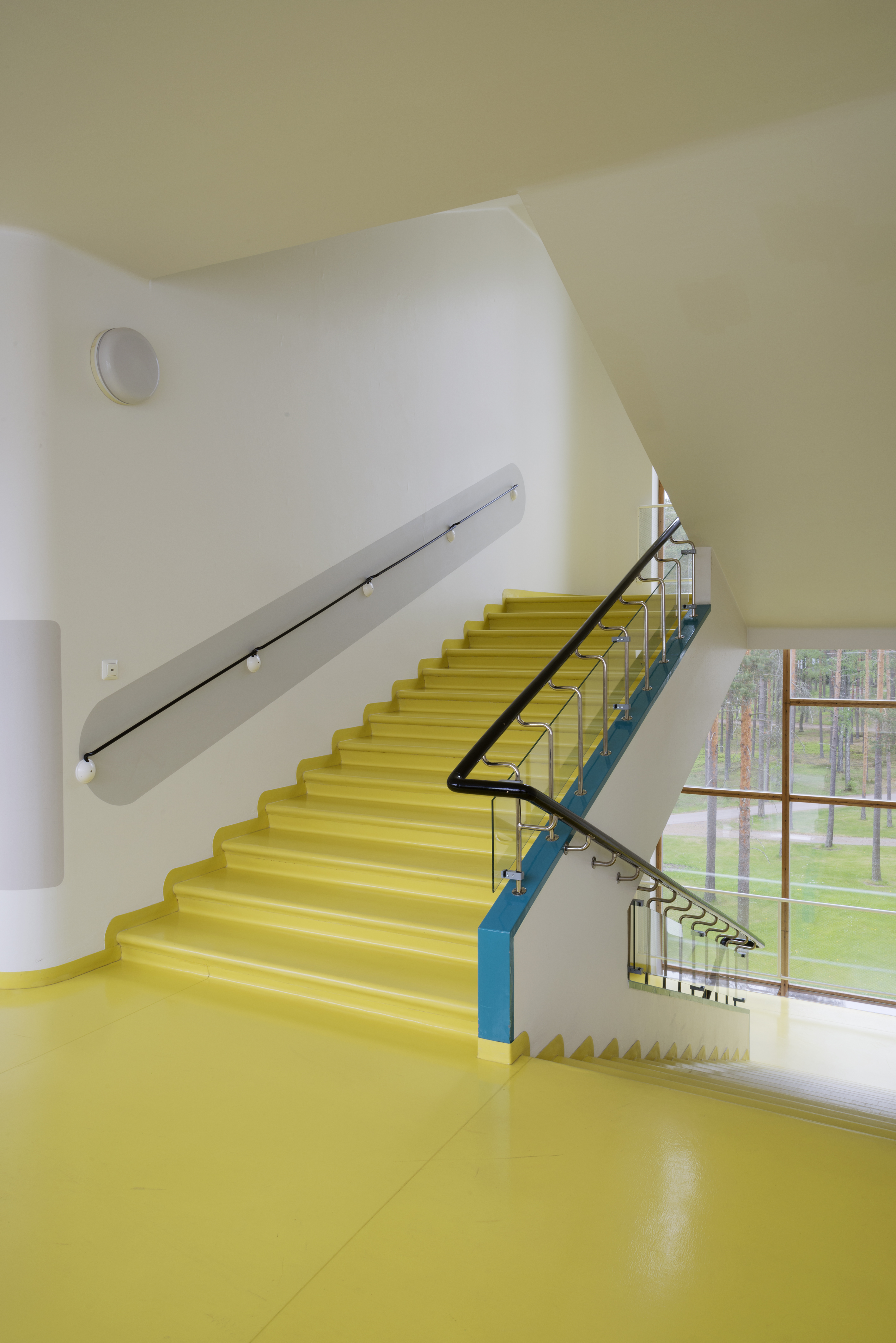View of bright yellow staircase in the Paimio Sanatorium.
