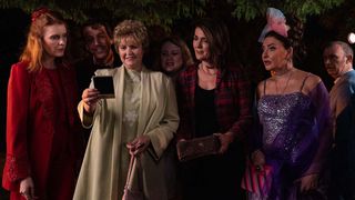 Derry Girls: Ma Mary and her old schoolfriends look at a photo from their past at the school reunion.