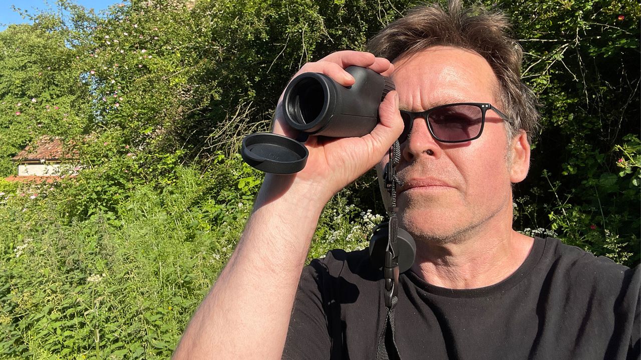 The author using the Opticron Oregon 4 PC Oasis 10X42 while wearing glasses