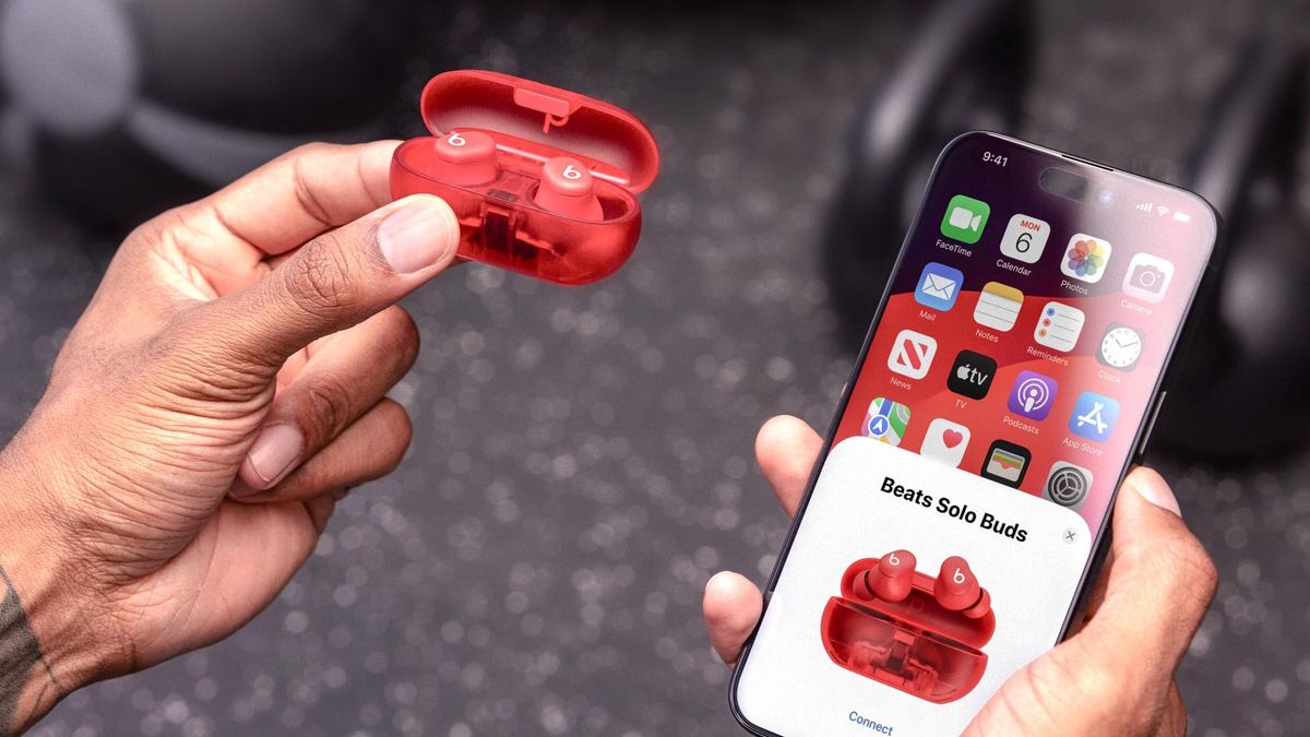 The Beats Solo Buds next to an iPhone in a gym setting.