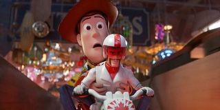 tom hank's woody and keanu reeve's duke caboom doing a motorcycle stunt jump in toy story 4