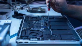 engineer repairs the laptop and the motherboard