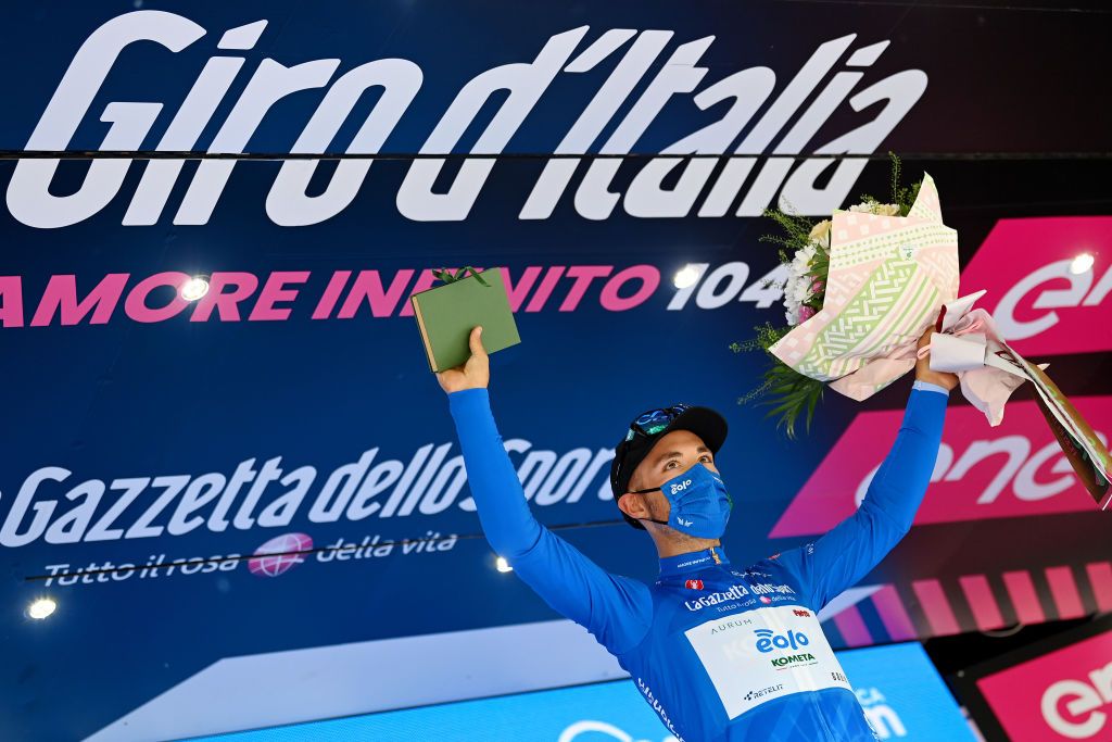 NOVARA ITALY MAY 09 Vincenzo Albanese of Italy and EOLOKOMETA Cycling Team blue mountain jersey celebrates at podium during the 104th Giro dItalia 2021 Stage 2 a 179km stage from Stupinigi Nichelino to Novara Mask Covid safety measures girodiitalia Giro UCIworldtour on May 09 2021 in Novara Italy Photo by Stuart FranklinGetty Images