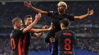 Lamine Yamal celebrates with his team-mates after scoring for Barcelona against Espanyol in a 2-0 win which saw the Blaugrana clinch the La Liga title in May 2025.