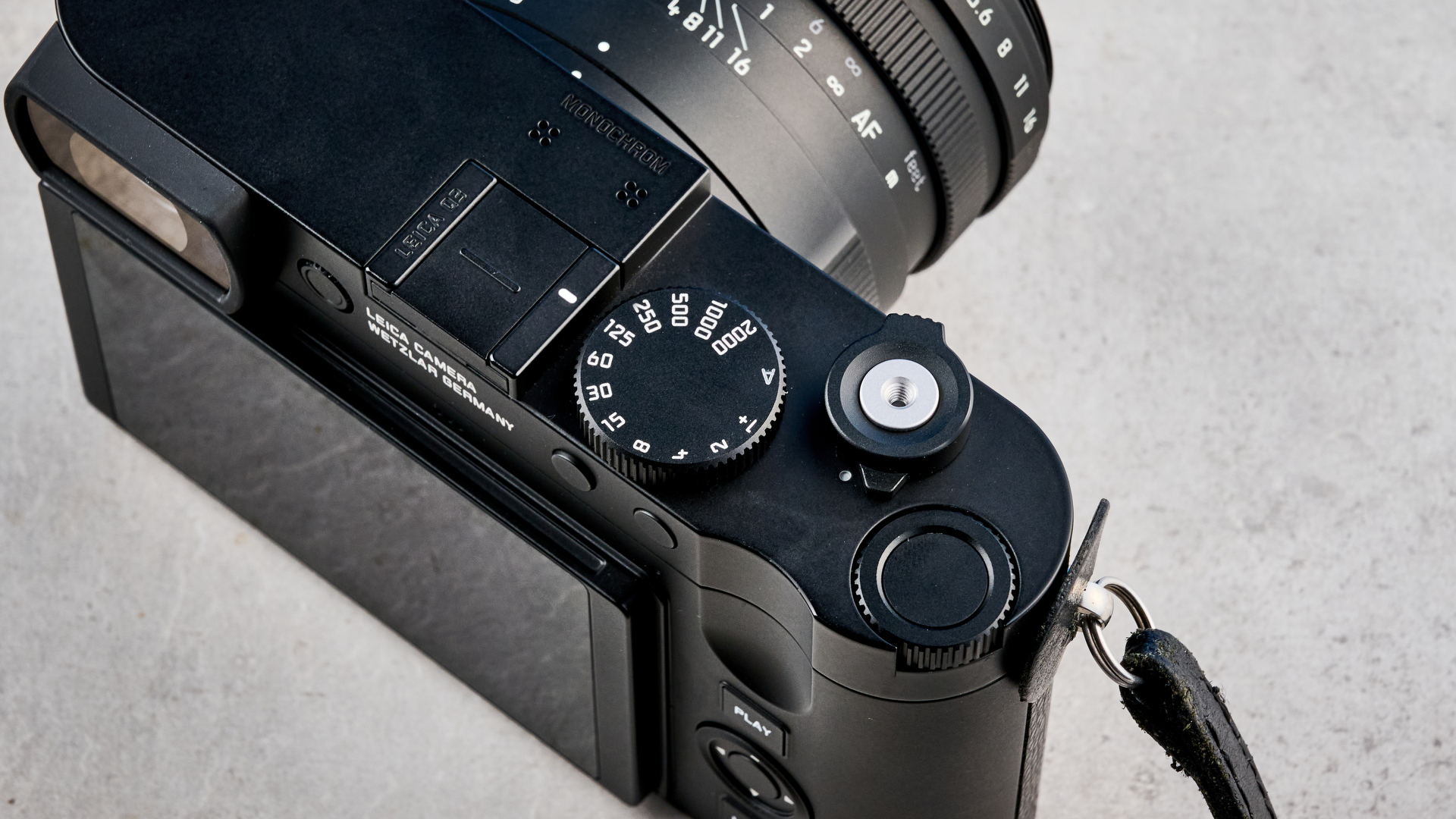 A black Leica Q3 Monochrom black-and-white mirrorless camera