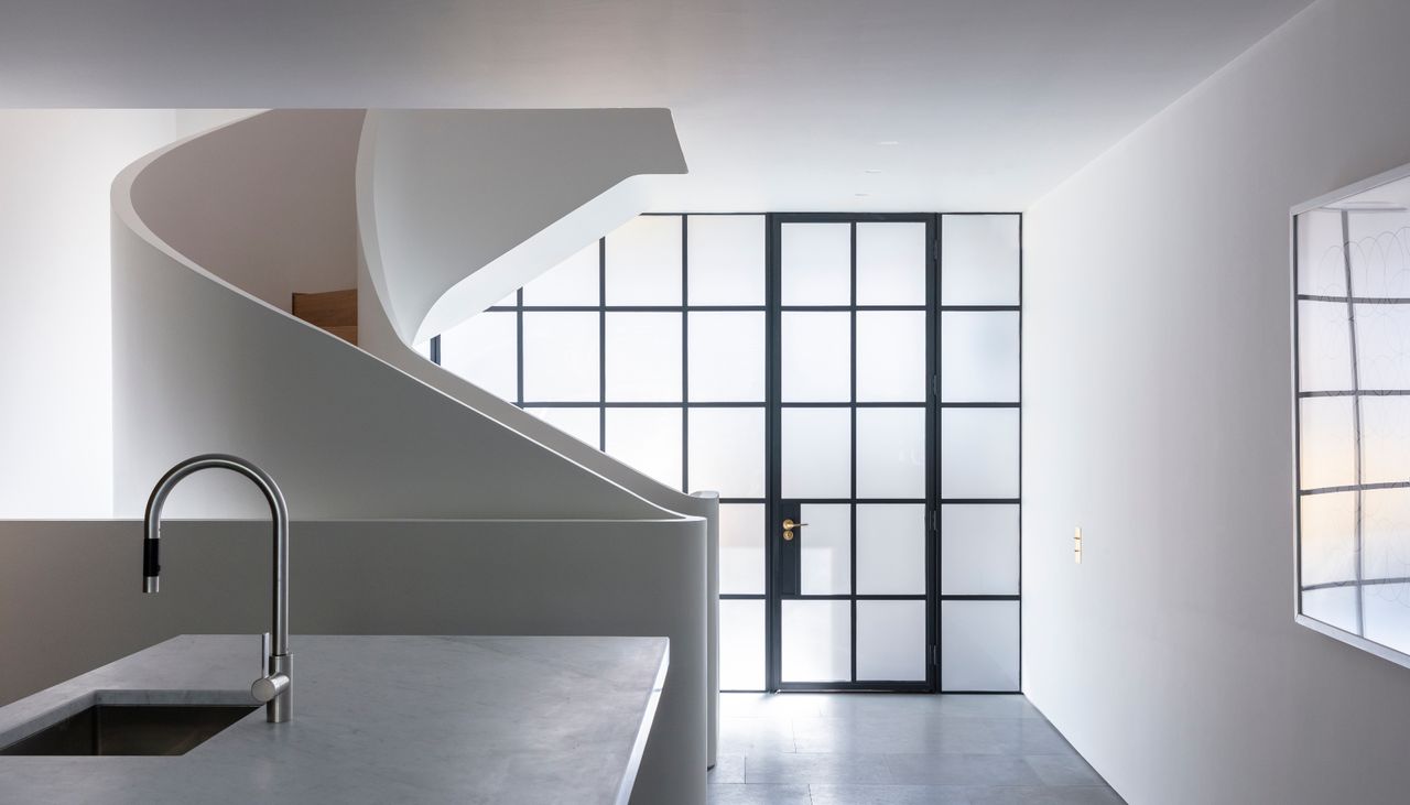 White spiral staircase next to kitchen