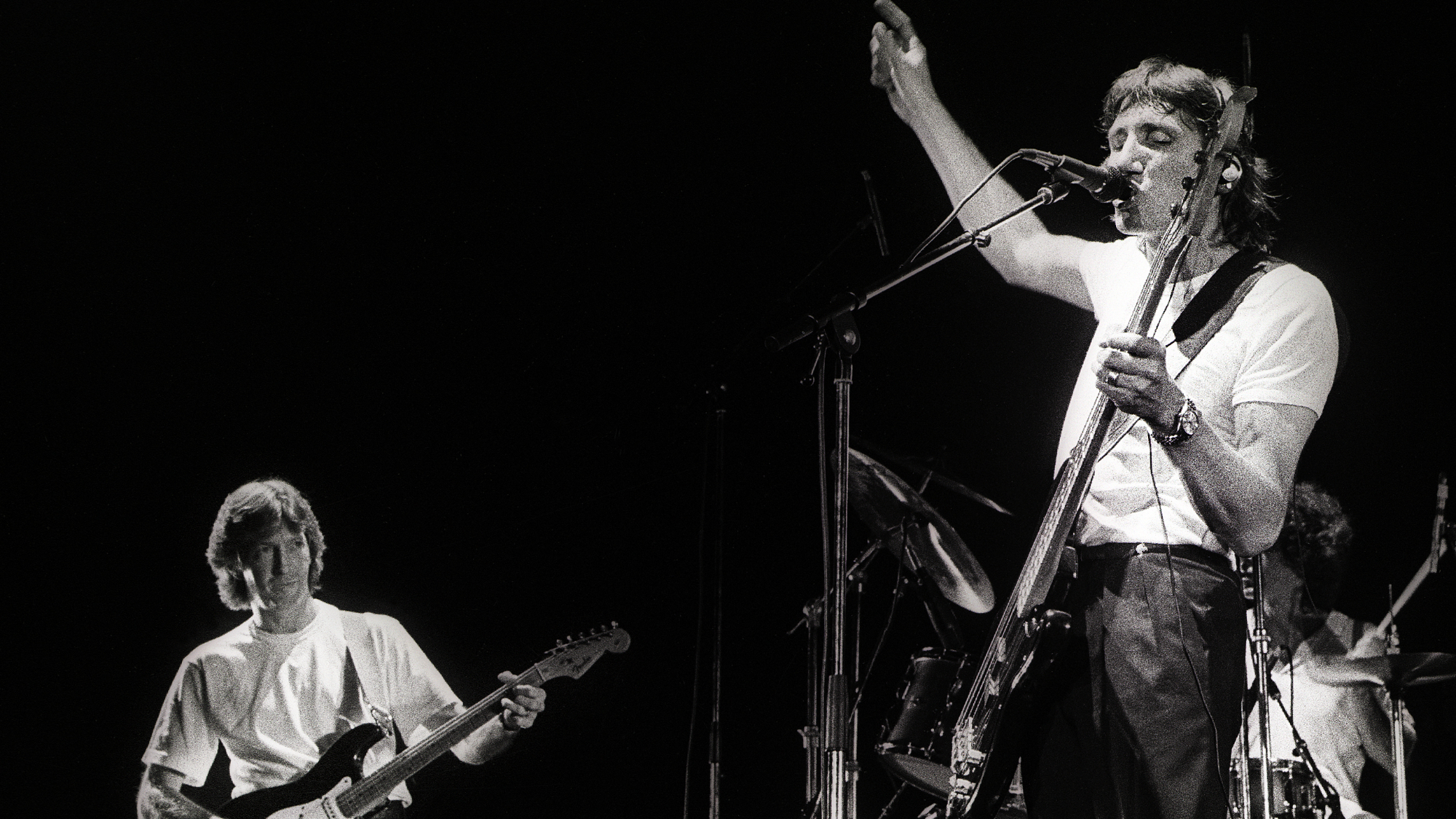 Eric Clapton (left) performs on stage as guest guitarist with Roger Waters (right) on Waters' 'Pros and Cons of Hitch Hiking' tour, Ahoy, Rotterdam, Netherlands, 19th June 1984