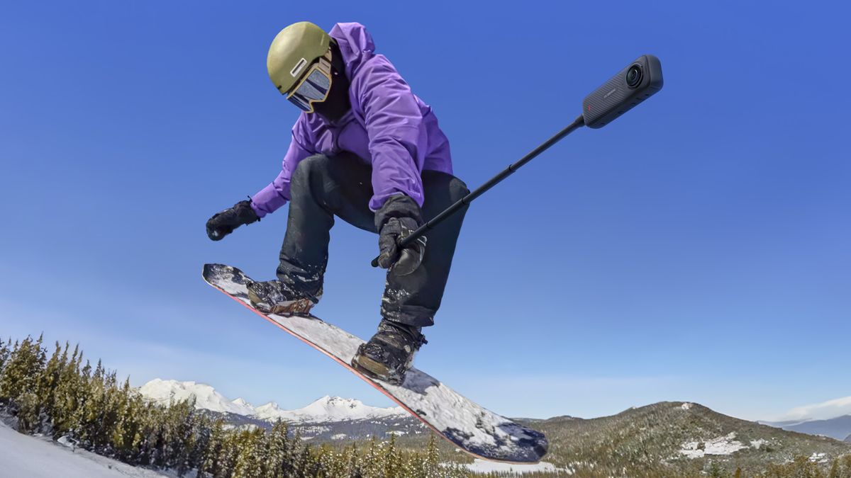 Snowboarding in the air holding the Insta360 X4 360 degree camera
