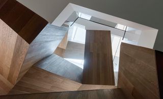 Artistically crafted, the staircase has a solid sculptural presence
