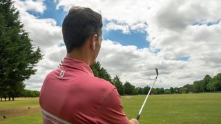 Golfer practicing with headphones