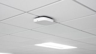 The Snap One Access Networks A770 Wi-Fi access point installed in a tiled ceiling. 