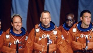 bruce willis and ben affleck in orange space suits leading a team of astronauts in the movie armageddon