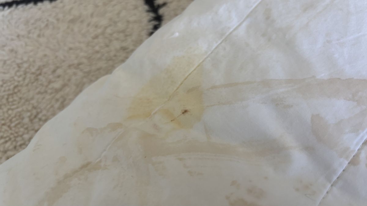 A pillow with a yellow stain.