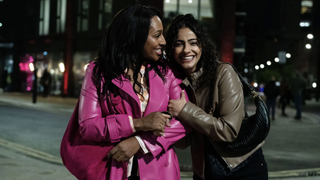 Helen (Alexandra Burke) and Sarah (Mandip Gill) embrace happily on a night out in Curfew