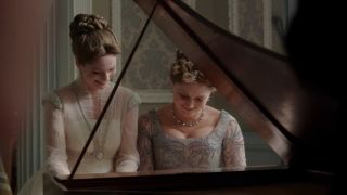 Francesca and Violet playing the pianoforte together.