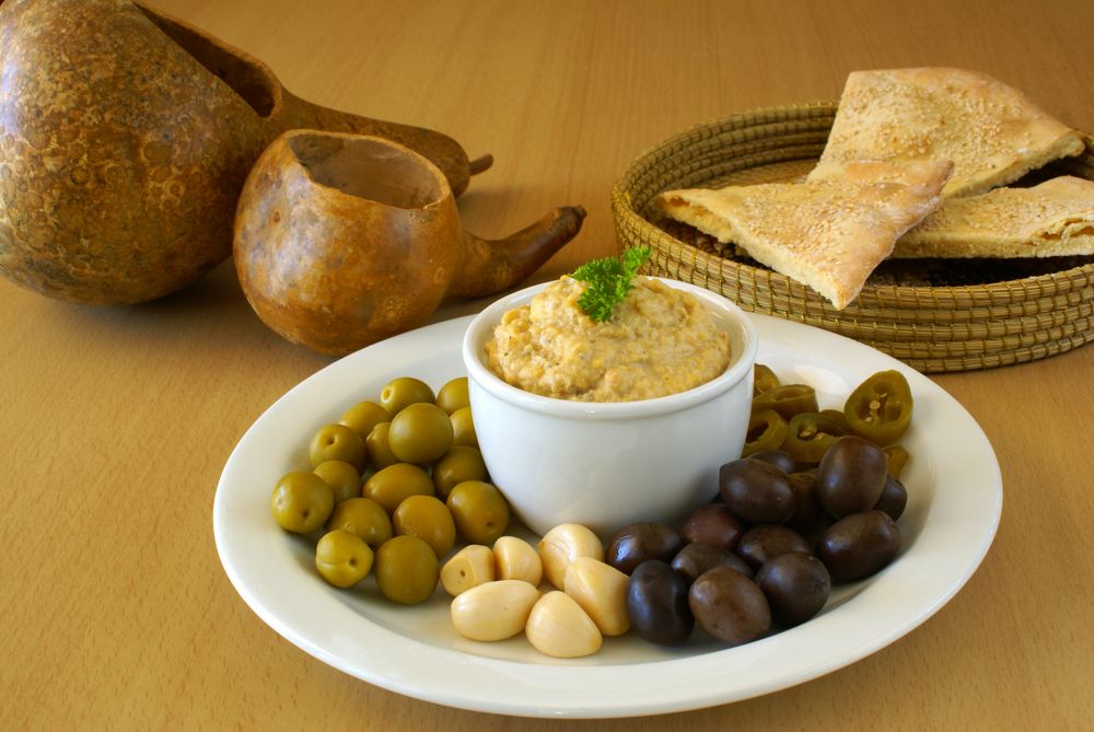 Hummus and olives on a plate